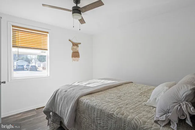a bedroom with a large bed and a potted plant