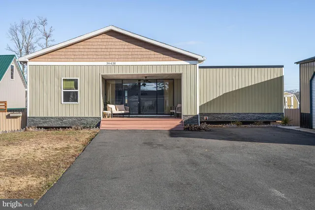 a view of a kitchen with kitchen island a sink wooden floor and a counter top space