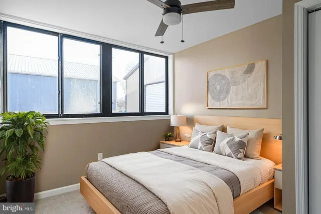 a view of a livingroom with wooden floor and windows