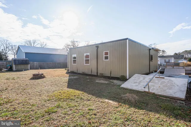 an aerial view of a residential houses with outdoor space