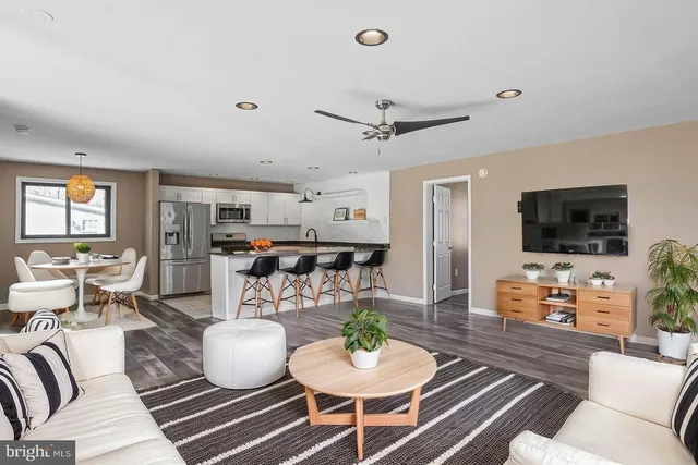 a kitchen with stainless steel appliances granite countertop a refrigerator and a stove top oven