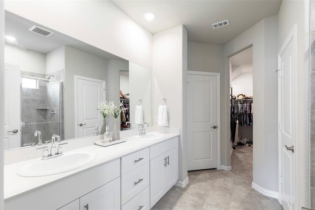 1504 Cobblestone Road Melissa, TX 75454 - Photo 20 of 39 Clean, bright ensuite with oversized walk in shower. Beyond it all, the extra-large walk-in closet gives you the storage every primary suite should have.