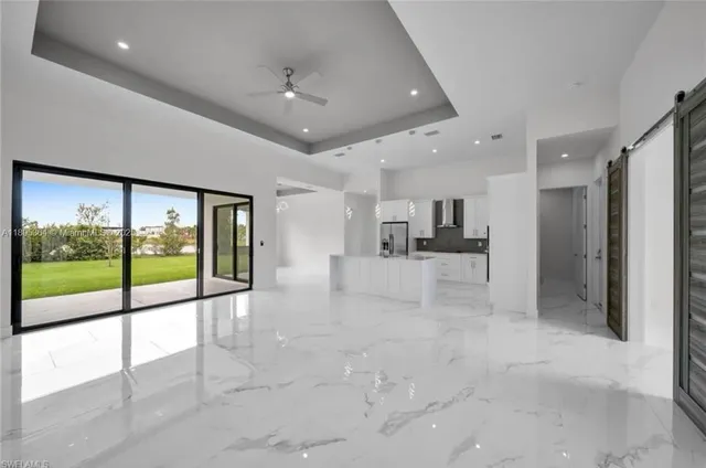 a view of a hallway with wooden floor and cabinet