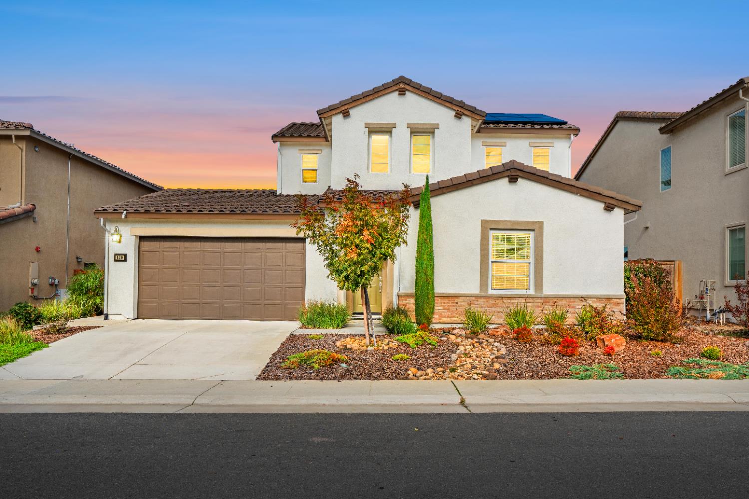 a front view of a house with a yard and garage