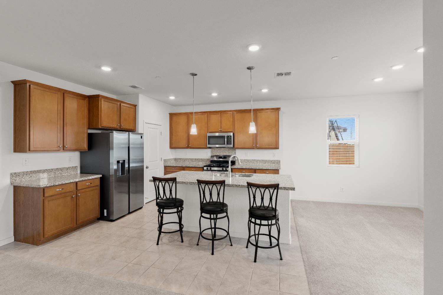 620 River Street Lincoln, CA 95648 - Photo 18 of 60 a kitchen with stainless steel appliances kitchen island granite countertop a refrigerator and a stove top oven
