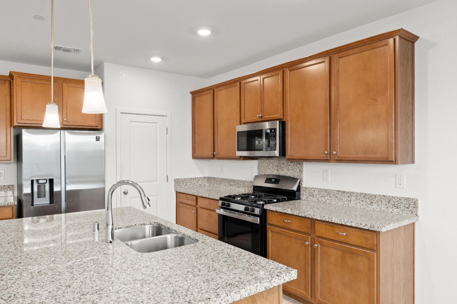 620 River Street Lincoln, CA 95648 - Photo 26 of 60 a kitchen with stainless steel appliances granite countertop a sink stove and microwave