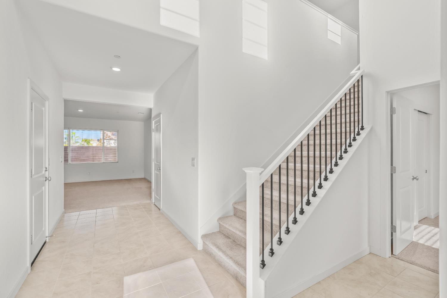 620 River Street Lincoln, CA 95648 - Photo 7 of 60 a view of an entryway with wooden floor leading to a furnished livingroom and windows