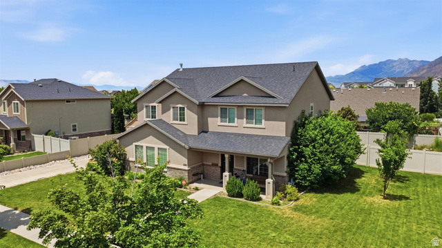592 West 650 South Springville, UT 84663 - Photo 28 of 33 Two-story residence featuring a gray shingle roof, neutral stucco siding, and stone accents on the lower level