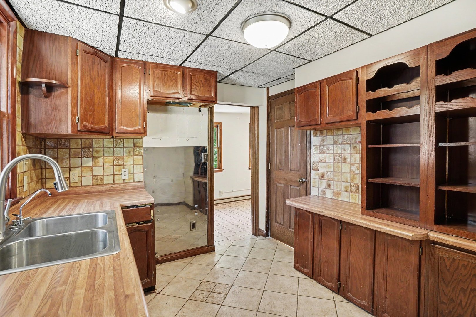 1661 Burr Oak Road Homewood, IL 60430 - Photo 7 of 17 a kitchen with stainless steel appliances granite countertop a sink a stove and a refrigerator