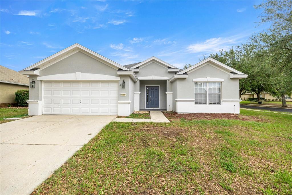 5533 Southwest 45th Street Ocala, FL 34474 - Photo 1 of 1 a view of a house with a yard and large tree