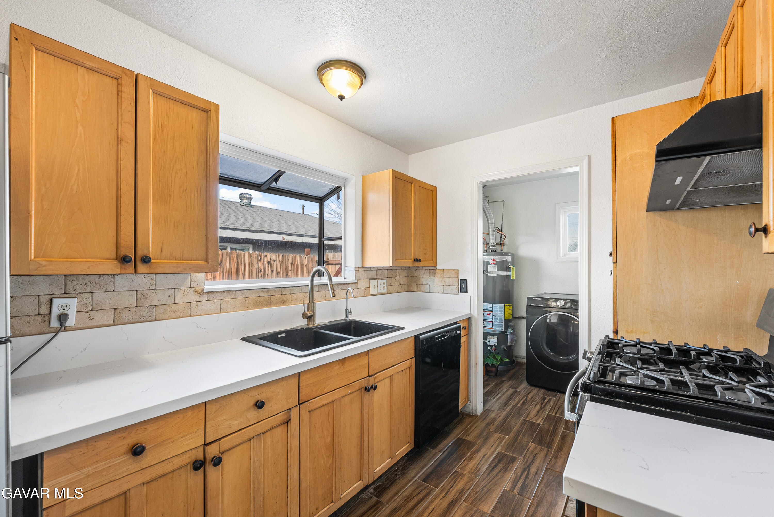 a kitchen with a sink stove and cabinets