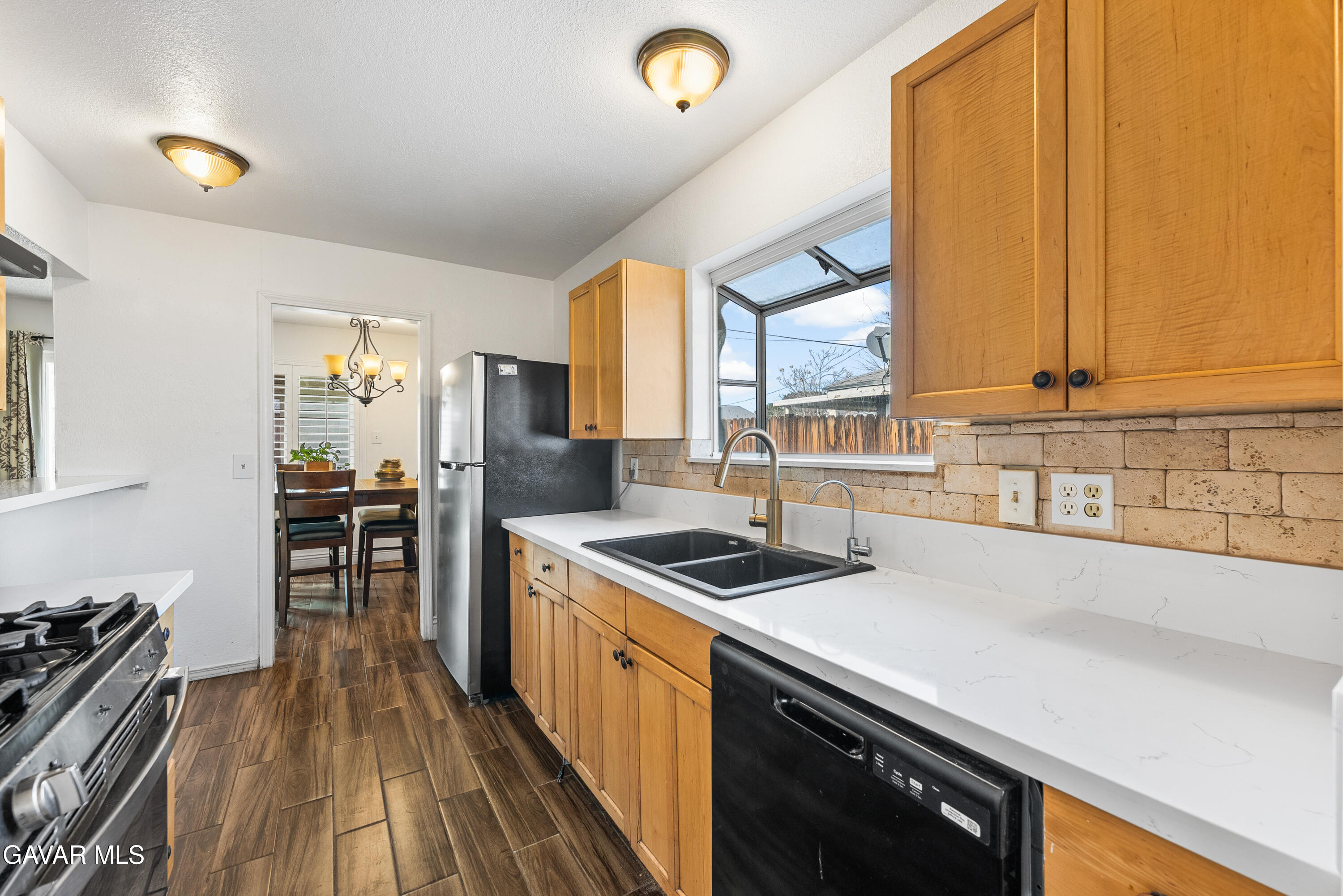 45323 Andale Avenue Lancaster, CA 93535 - Photo 14 of 28 a kitchen that has a sink and a stove