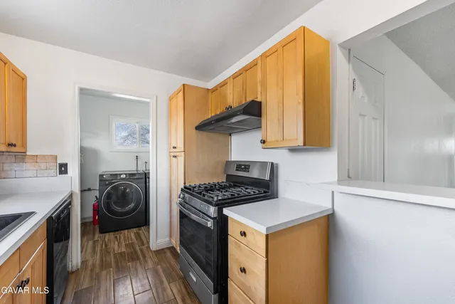 a kitchen with a stove a sink and a refrigerator