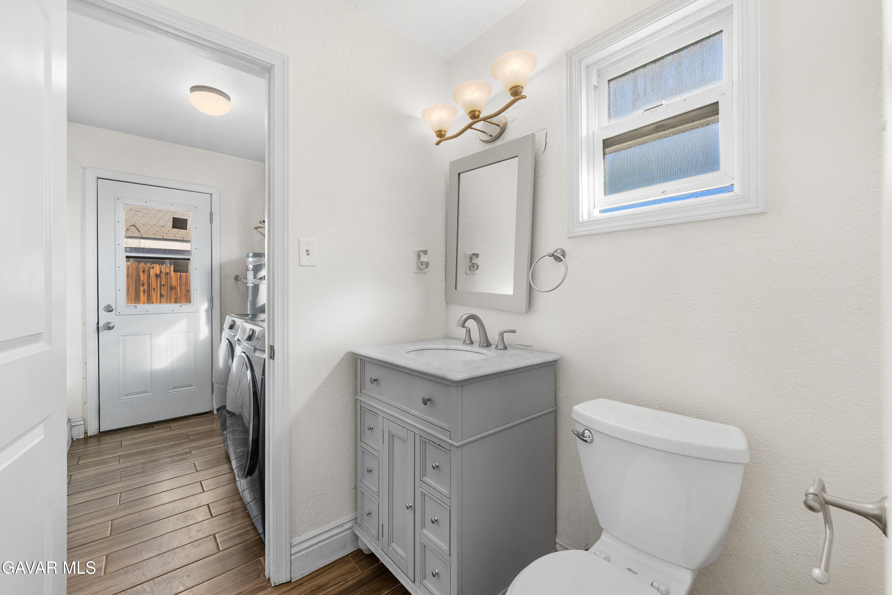 45323 Andale Avenue Lancaster, CA 93535 - Photo 18 of 28 a bathroom with a toilet sink and mirror