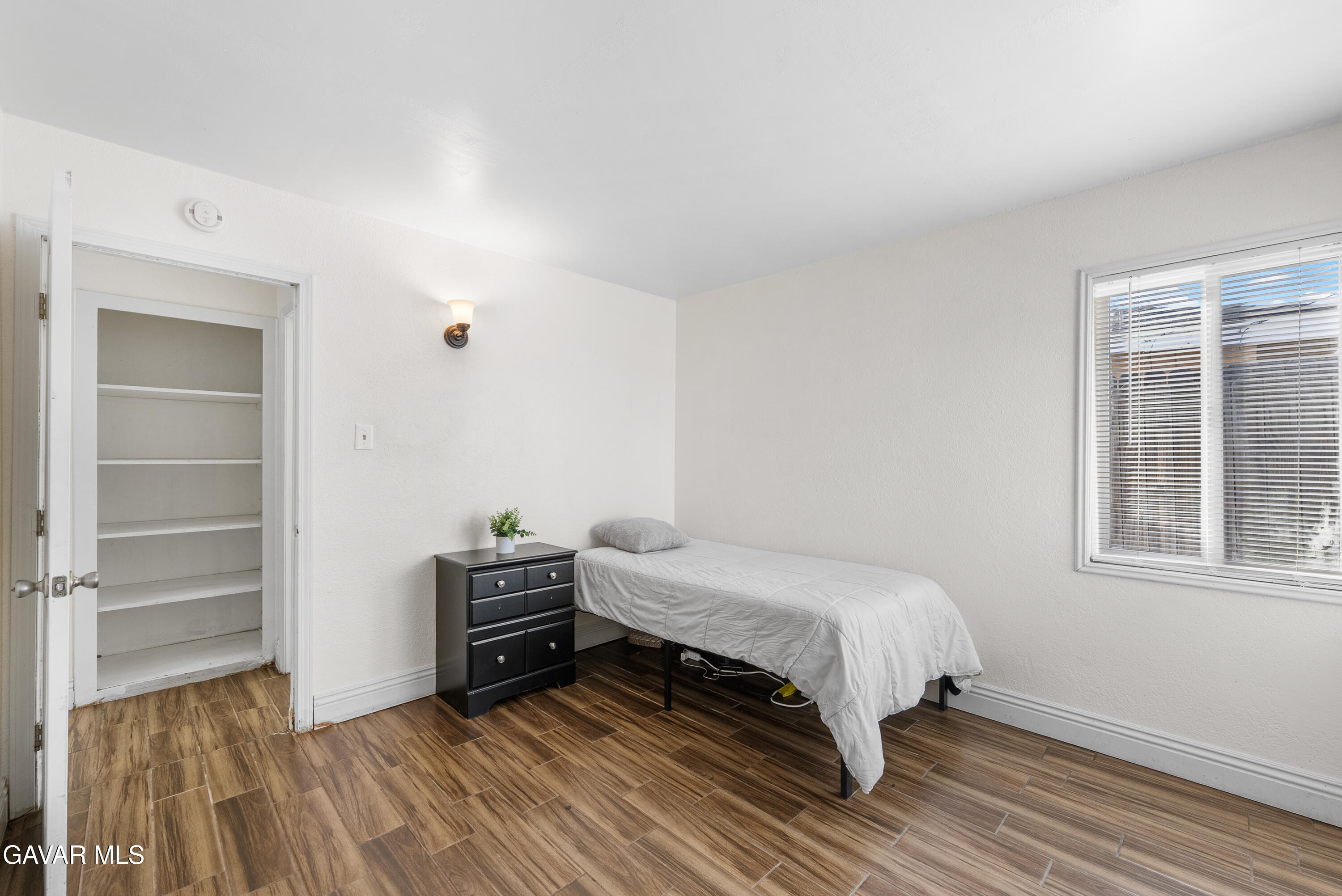 45323 Andale Avenue Lancaster, CA 93535 - Photo 20 of 28 a bedroom with a bed and a window