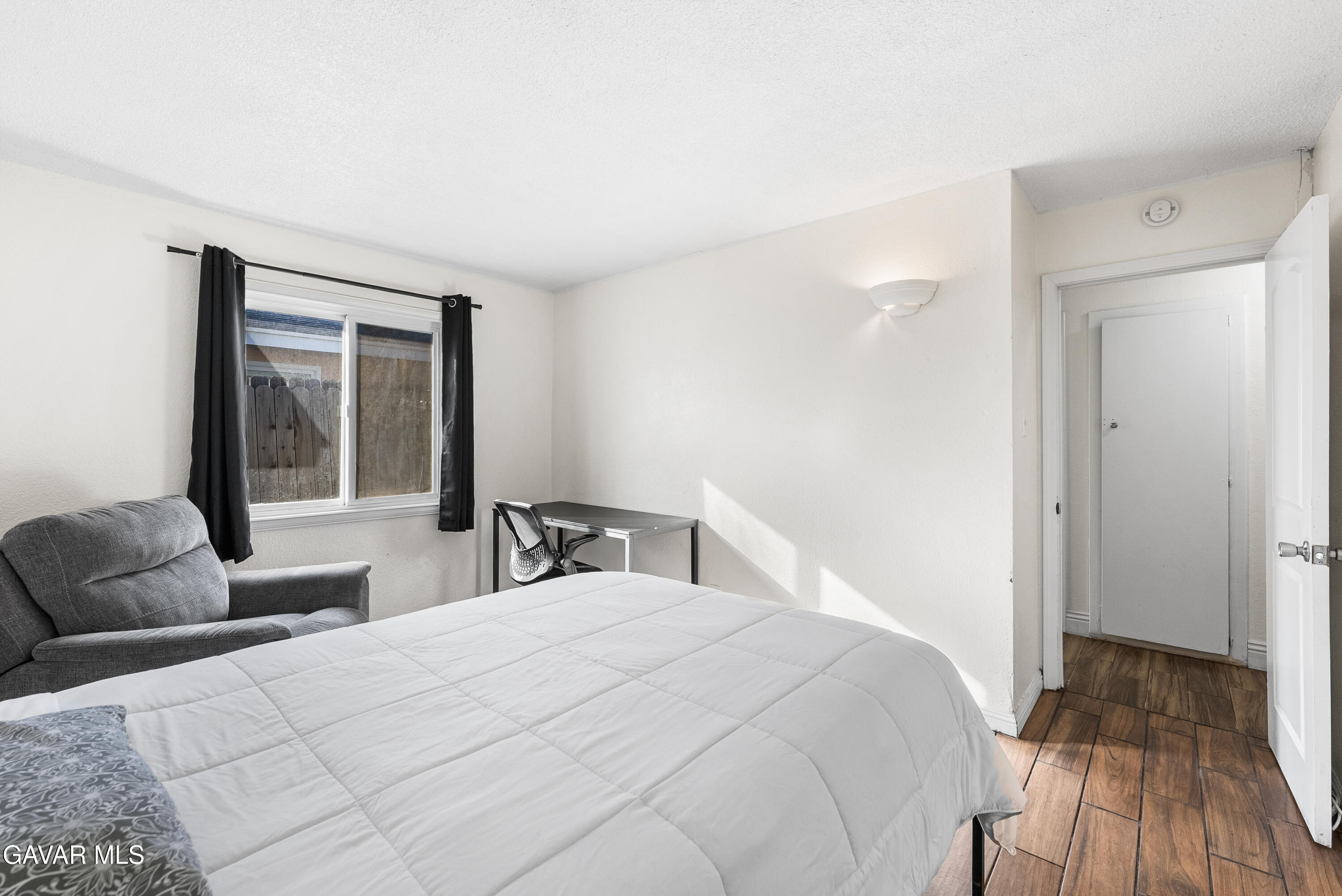 45323 Andale Avenue Lancaster, CA 93535 - Photo 22 of 28 a bedroom with a bed and a large window