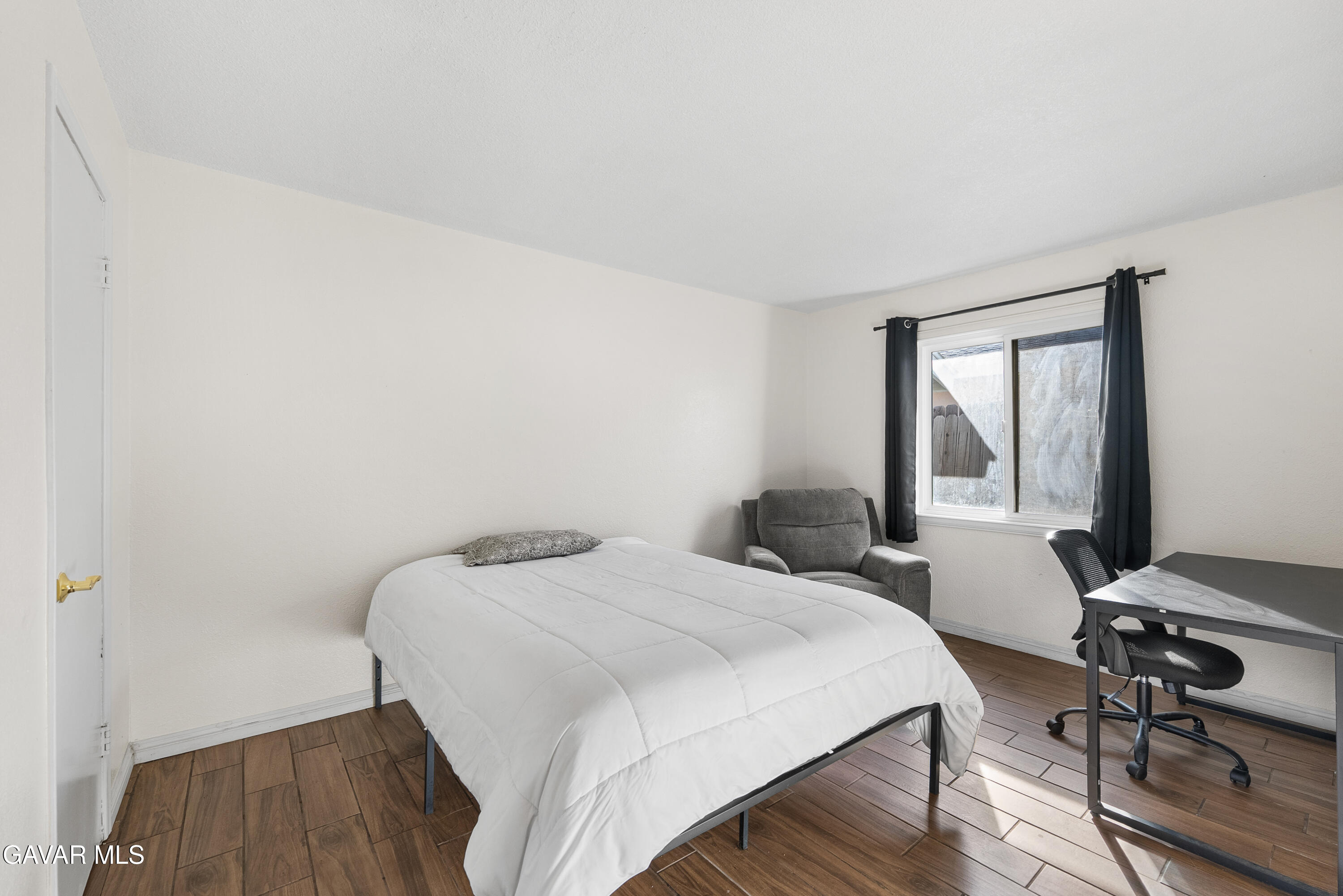 45323 Andale Avenue Lancaster, CA 93535 - Photo 23 of 28 a bedroom with a bed and a table