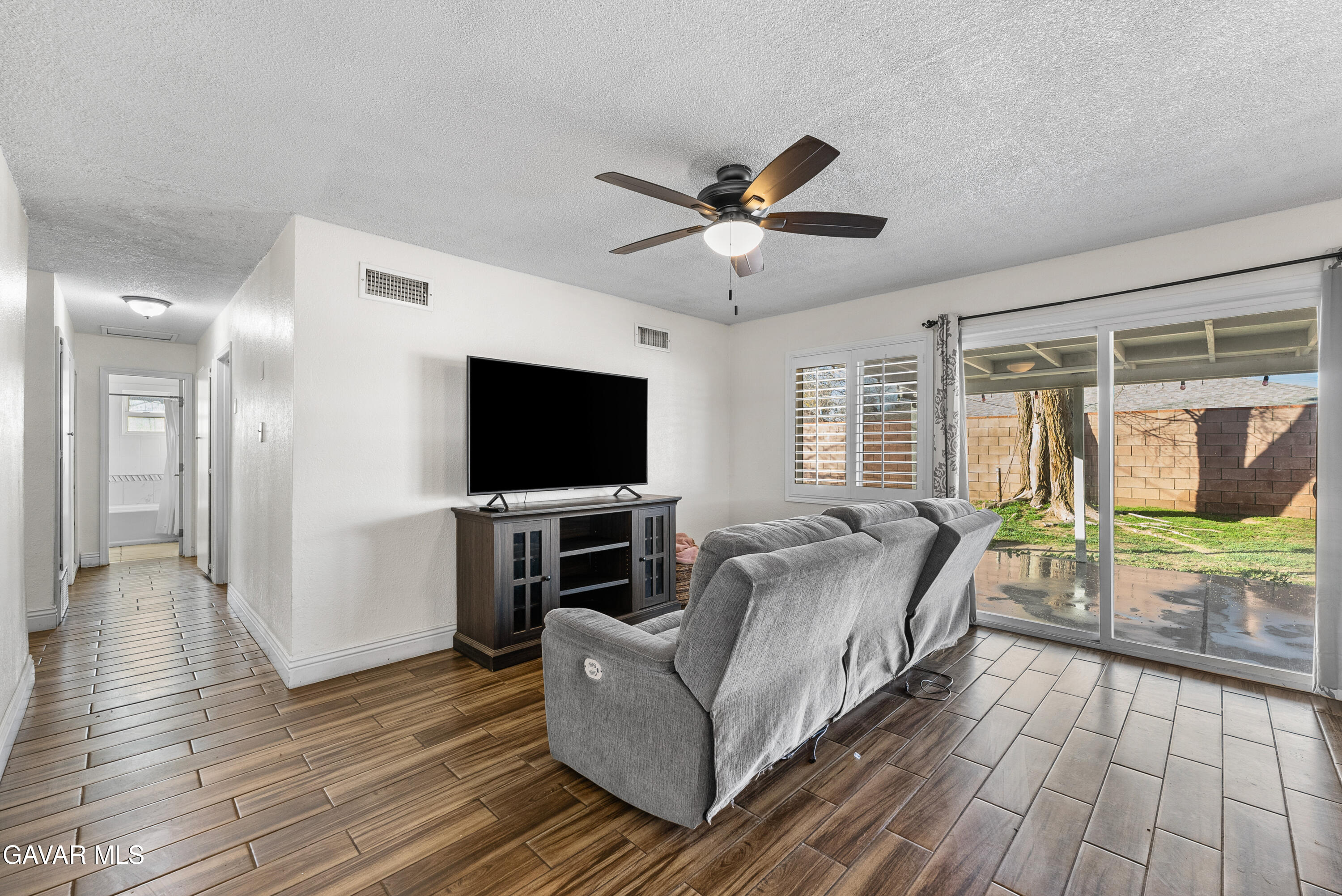 45323 Andale Avenue Lancaster, CA 93535 - Photo 5 of 28 a living room with furniture and a flat screen tv