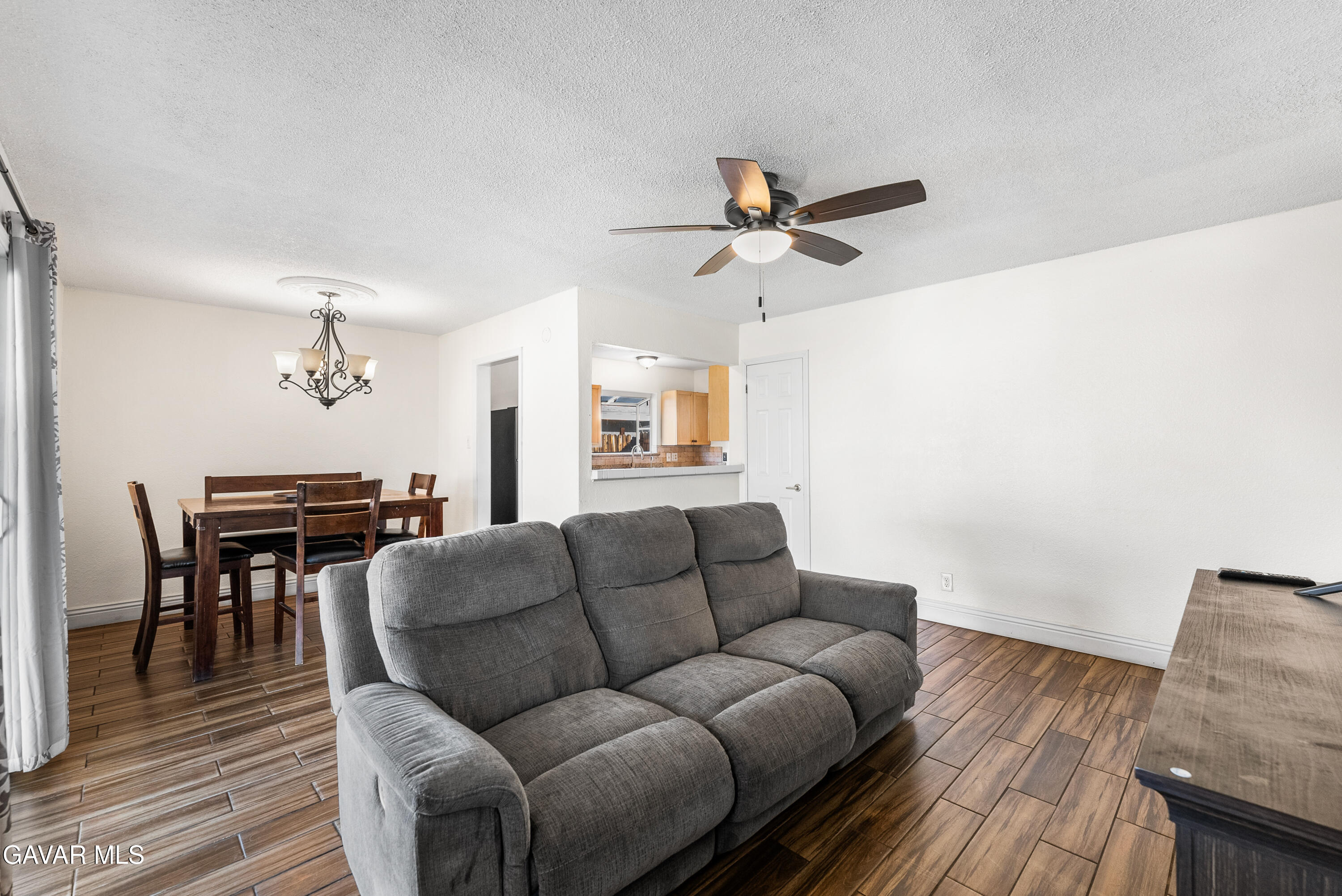 45323 Andale Avenue Lancaster, CA 93535 - Photo 7 of 28 a living room with furniture a ceiling fan and a rug