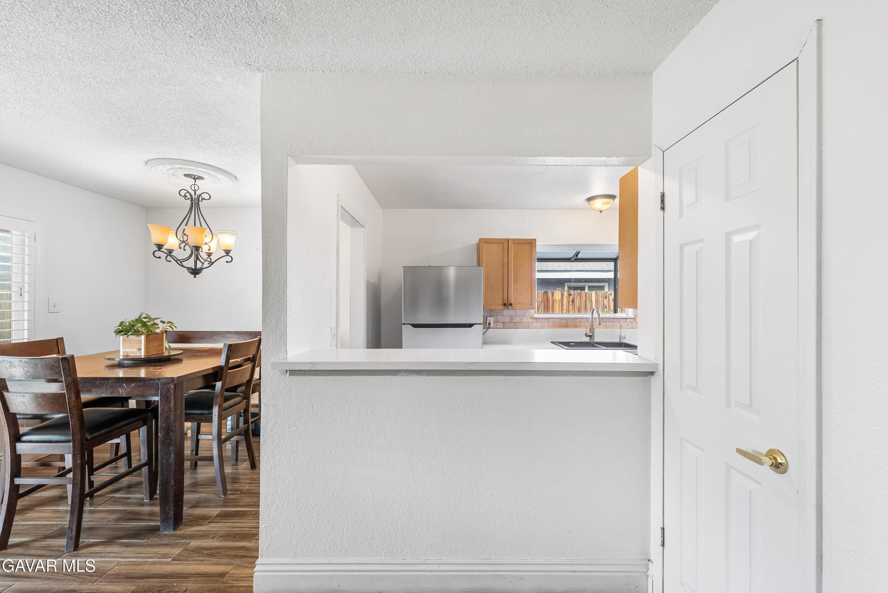 45323 Andale Avenue Lancaster, CA 93535 - Photo 9 of 28 a kitchen with stainless steel appliances granite countertop a table and chairs in it