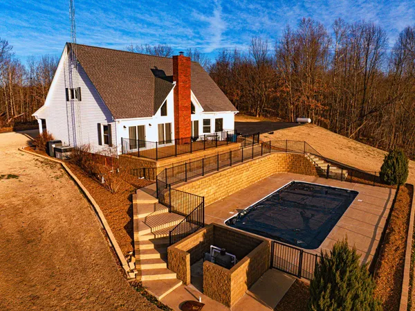 a view of a house with pool and sitting area