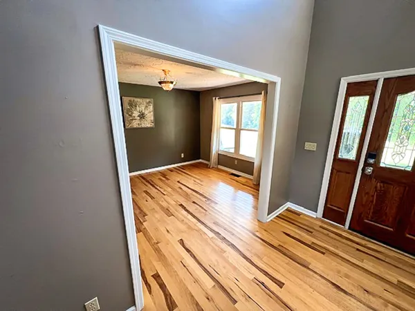 a bedroom with a bed and glass door