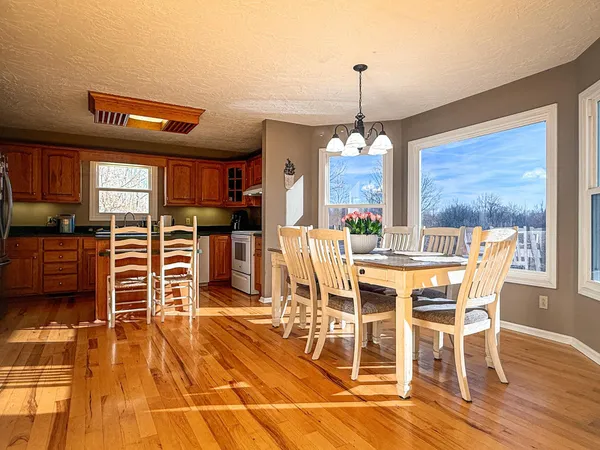 a view of a dining room with furniture window and wooden floor