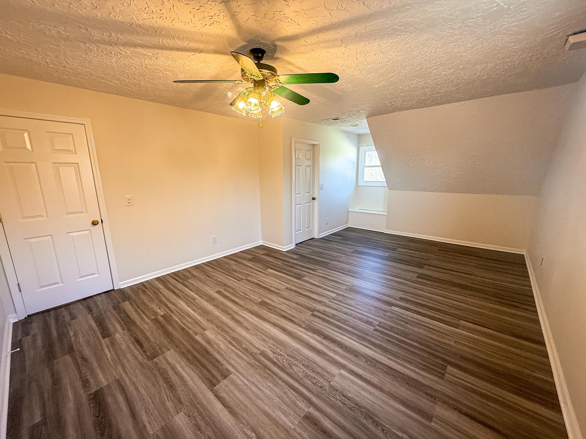 5030 Rogers Marshall Road Union City, TN 38261 - Photo 37 of 40 a view of empty room with wooden floor and fan