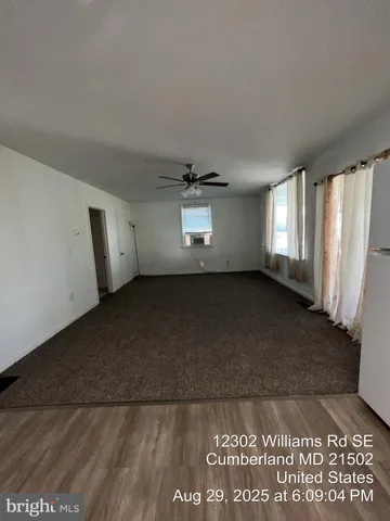 a view of an empty room and a window