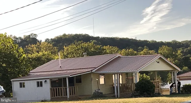 a aerial view of a house next to a yard