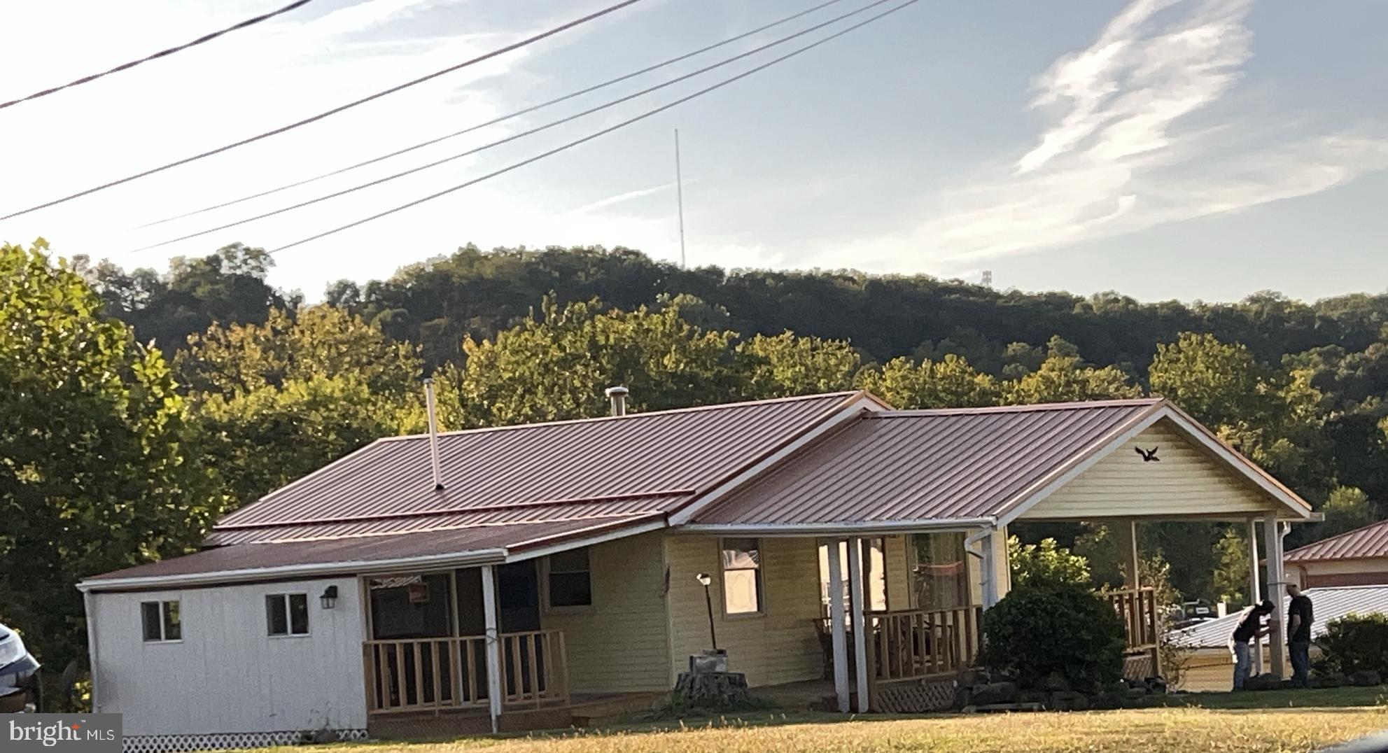 12302 Williams Road Southeast Cumberland, MD 21502 - Photo 2 of 35 a aerial view of a house next to a yard