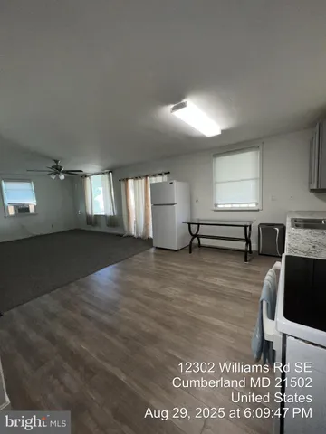a view of a kitchen and an empty room