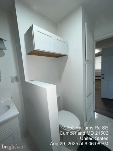 a view of an empty room and a window