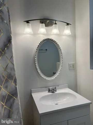 a bathroom with a sink and mirror