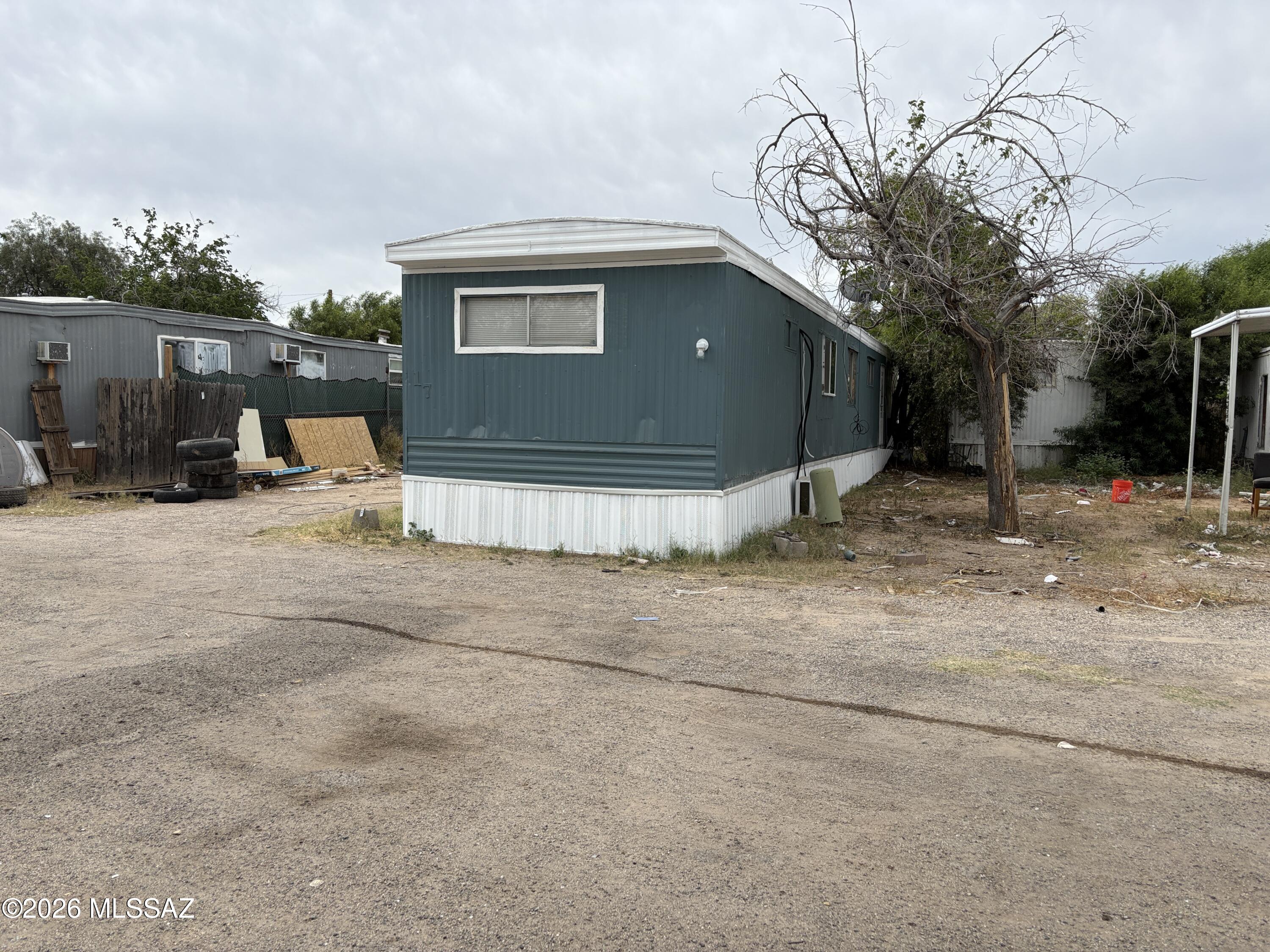 1741 West Wetmore Road, Unit 17 Tucson, AZ 85705 - Photo 2 of 9 a view of a house with a patio