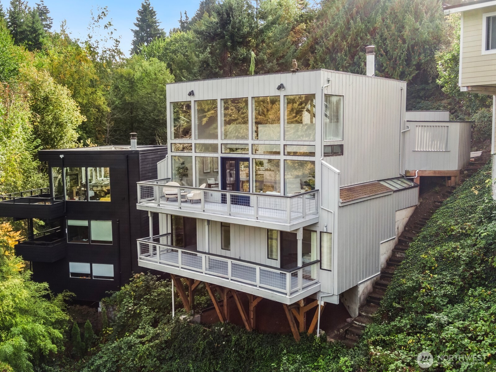 aerial view of a house with roof deck and seating space