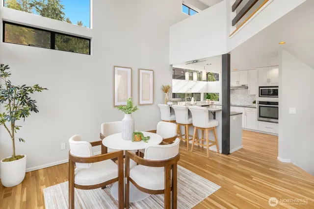 a dining room with furniture and wooden floor