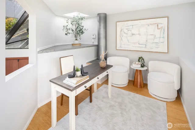 a living room with furniture a table and a potted plant