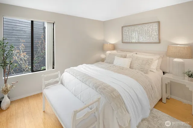 a bedroom with a bed and a large window