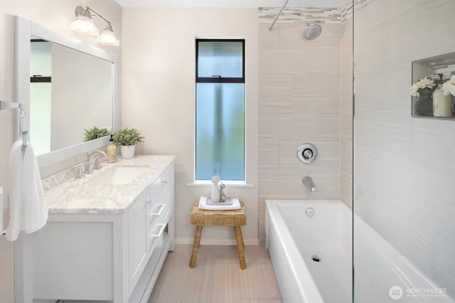 a bathroom with a granite countertop sink a toilet and bathtub