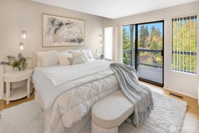 a bedroom with a large bed and a painting on the wall