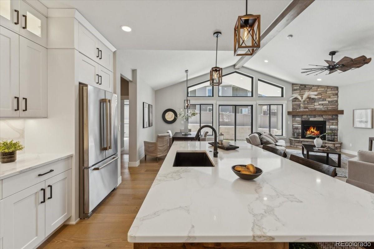 1361 Art Drive Berthoud, CO 80513 - Photo 12 of 40 a kitchen with sink refrigerator and stove