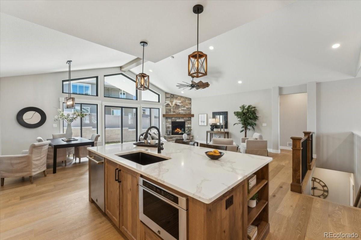 1361 Art Drive Berthoud, CO 80513 - Photo 14 of 40 a kitchen that has a stove a kitchen island a dining table and chairs in it