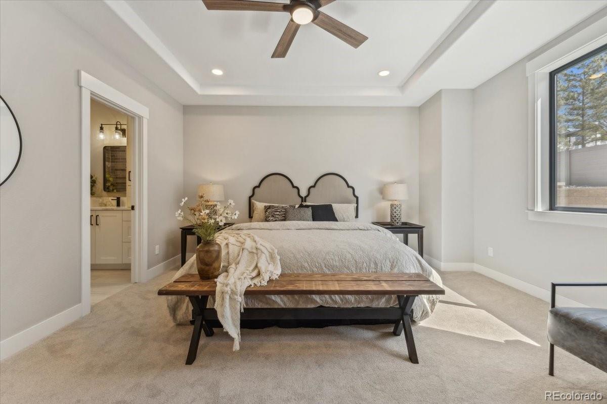 1361 Art Drive Berthoud, CO 80513 - Photo 17 of 40 a bed sitting in a room next to a window and a chandelier