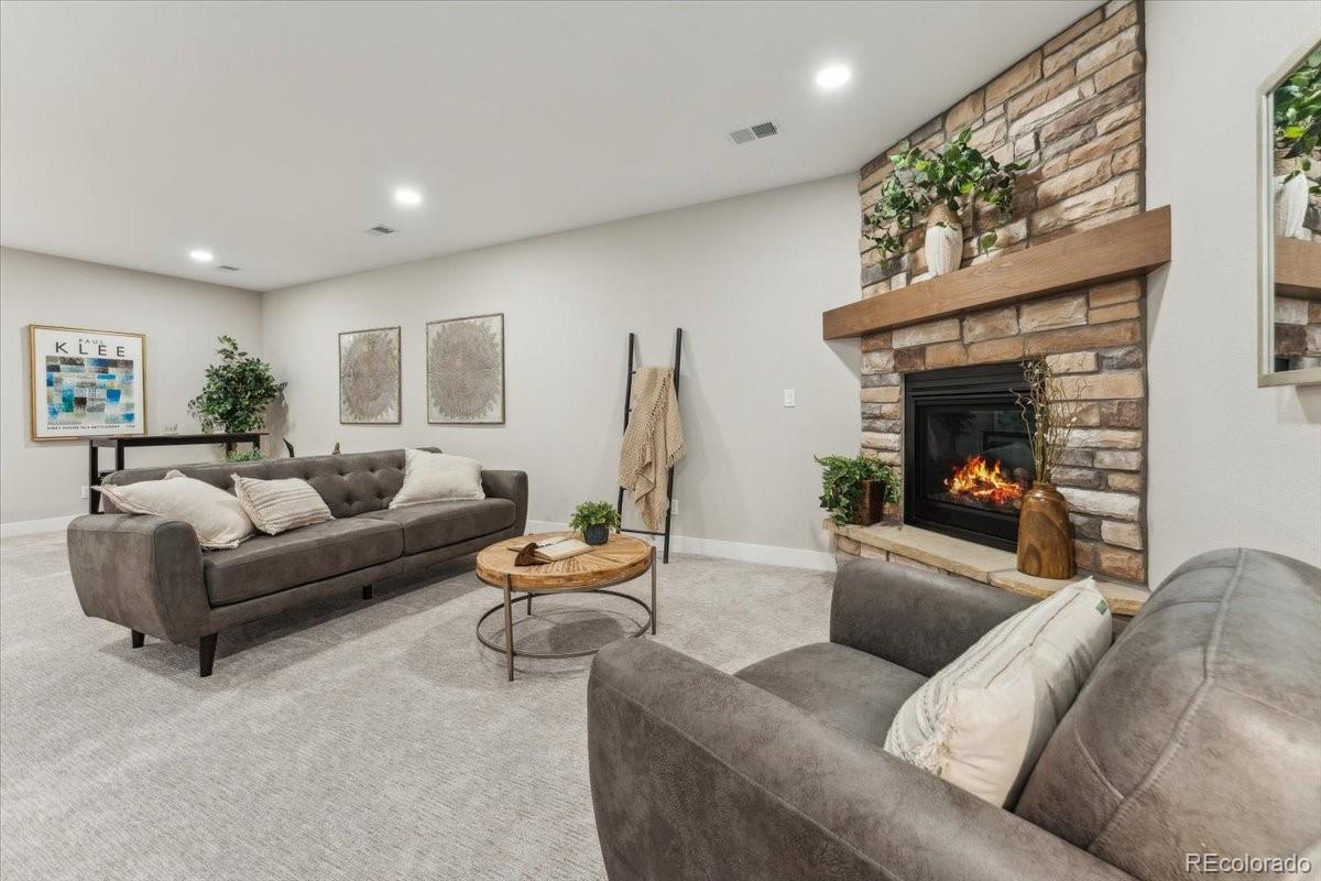 1361 Art Drive Berthoud, CO 80513 - Photo 36 of 40 a living room with furniture and a fireplace