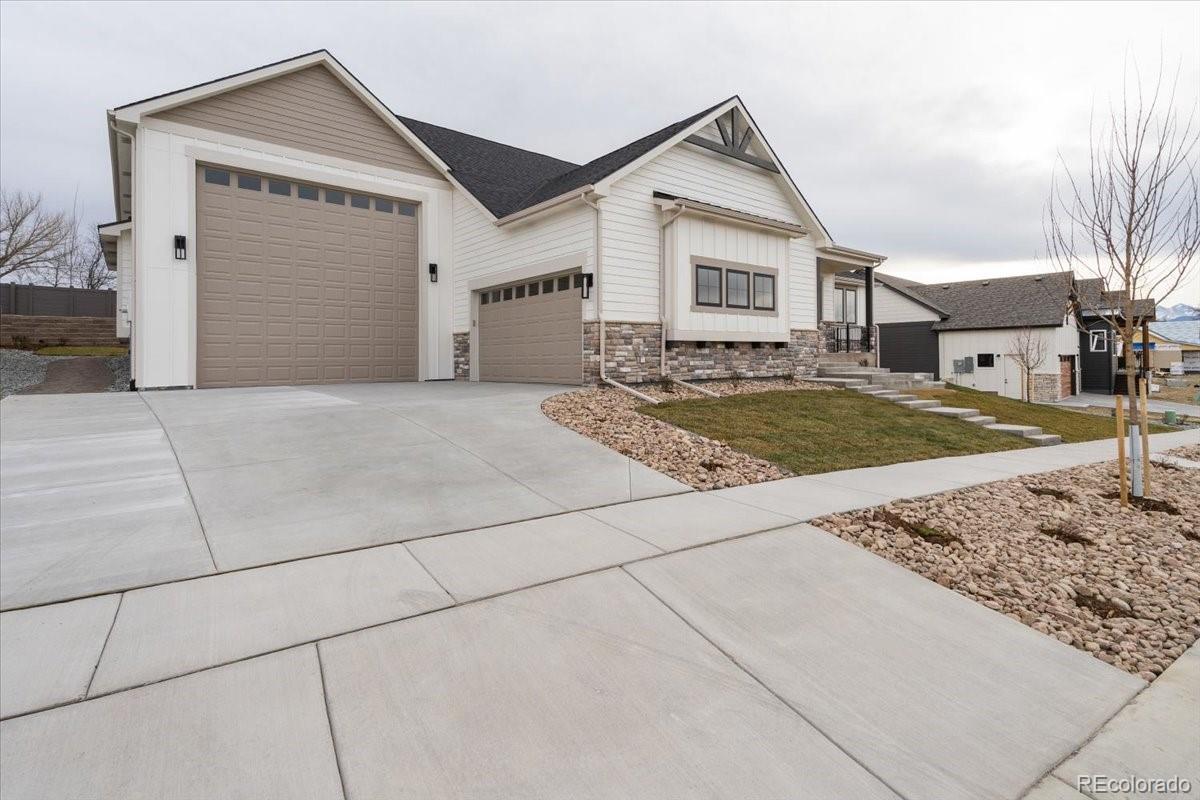 1361 Art Drive Berthoud, CO 80513 - Photo 8 of 40 a view of a house with a yard and garage