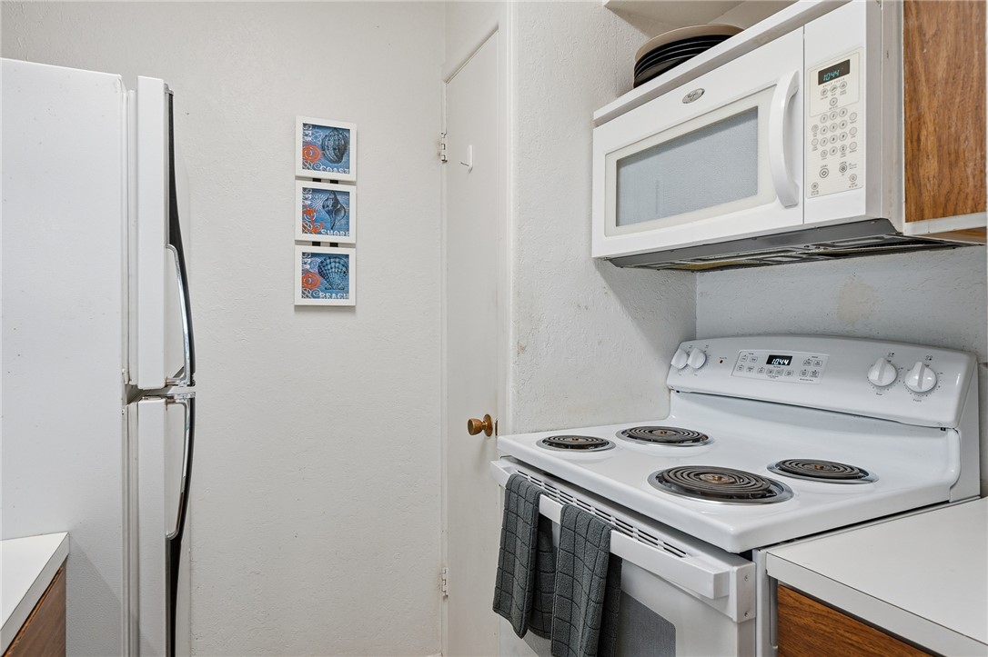 2003 North Fulton Beach Road, Unit 34 34 Rockport, TX 78382 - Photo 10 of 38 a kitchen with a stove and a refrigerator