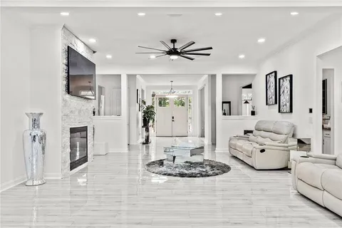 a living room with furniture fireplace and a chandelier