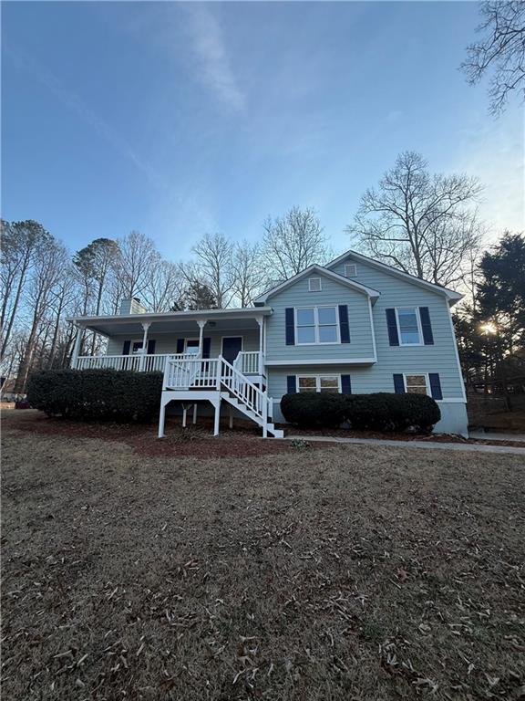 a white house that has a tree in front of it