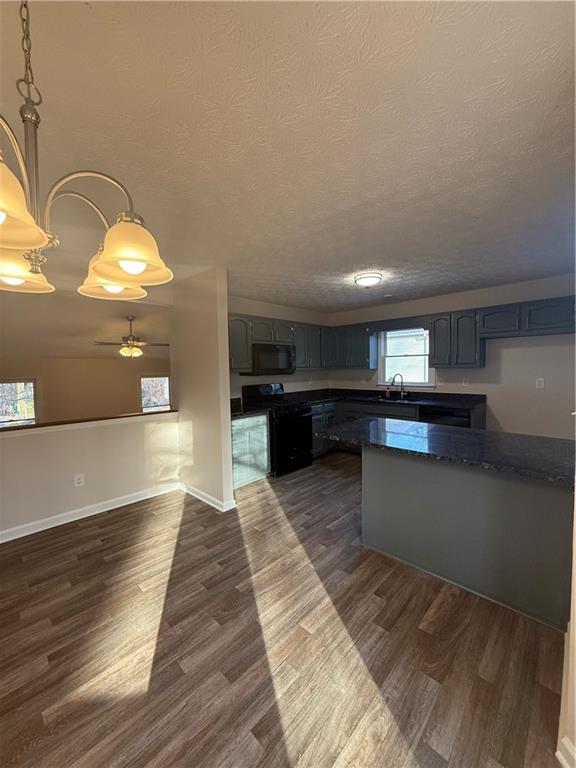 290 Mill Pointe Trail Dallas, GA 30157 - Photo 3 of 8 a view of a kitchen with kitchen island a sink wooden floor and stainless steel appliances